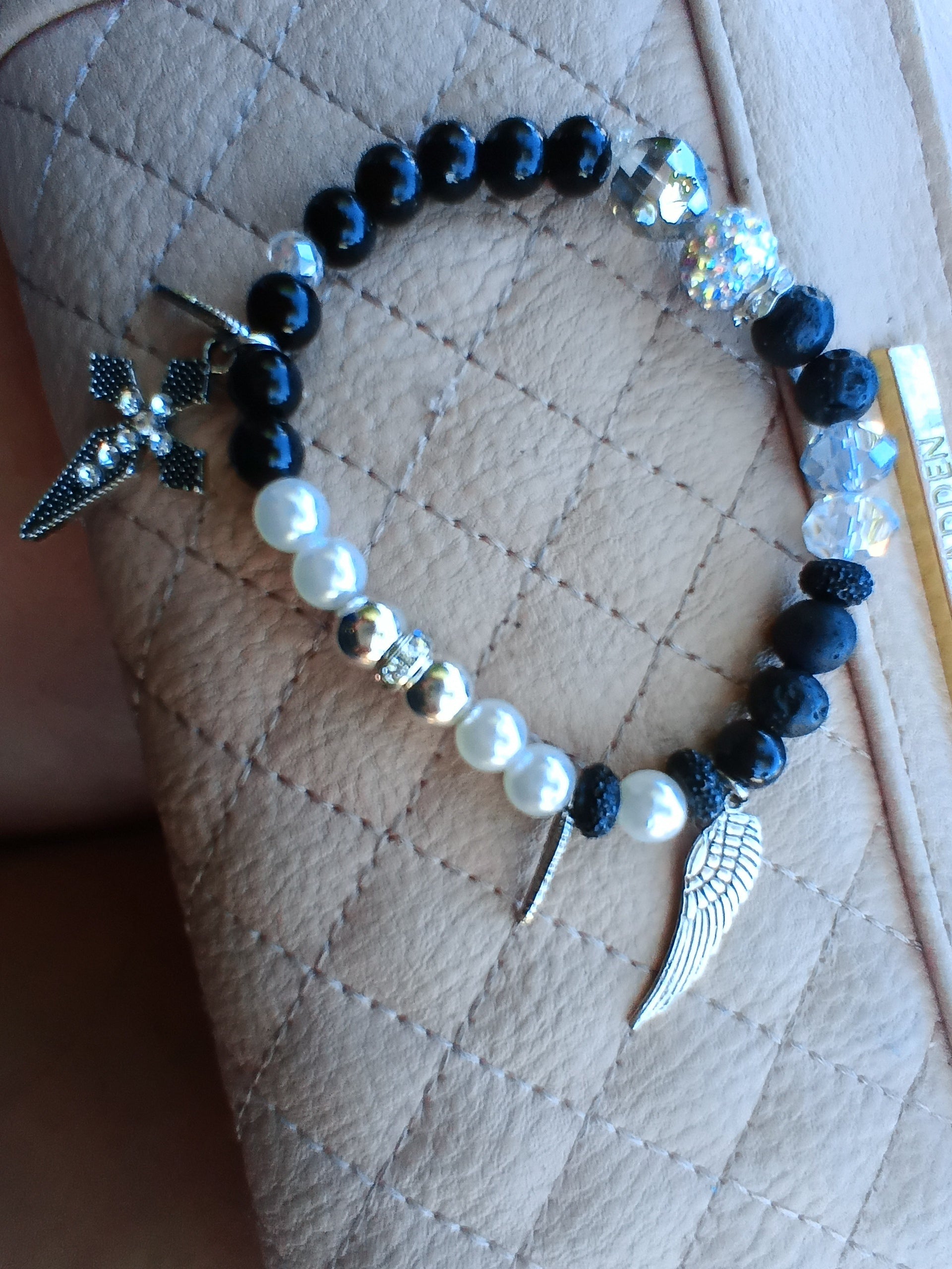 Black Angel memorial bracelet with lava beads, pearls, and angel wing charm